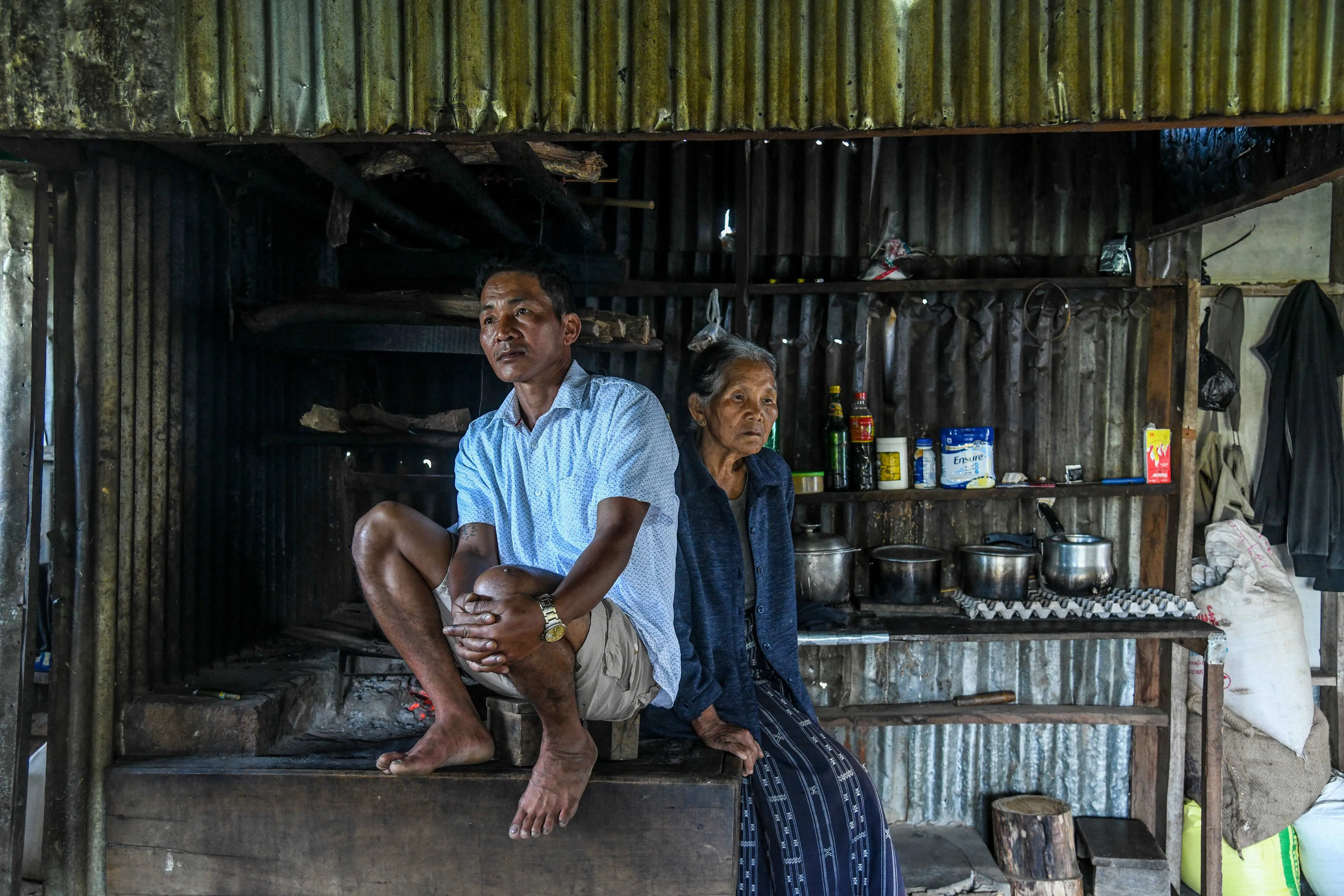 Ral That Chung, left, with his mother at their rented home in the Mizoram state of India, Oct. 15, 2021
